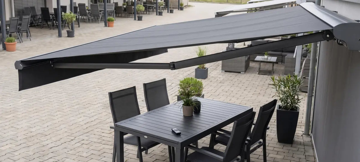 Motorized retractable awning over a patio with wireless remote control